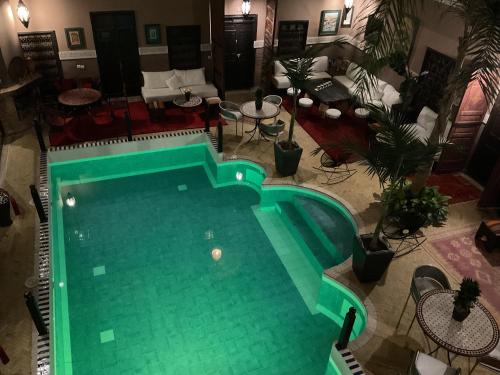 an overhead view of a swimming pool in a living room at Riad Syba in Marrakech