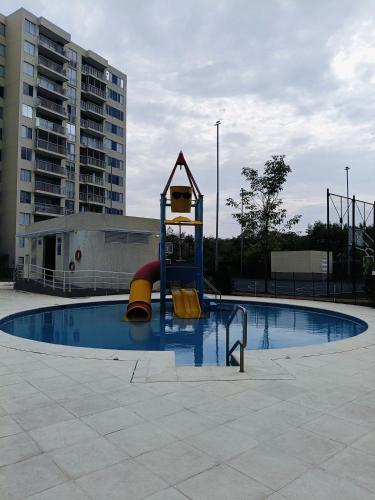 a playground in a pool with a slide in it at Apto completo Pto Azul Club House Ven a Descansar in Ricaurte