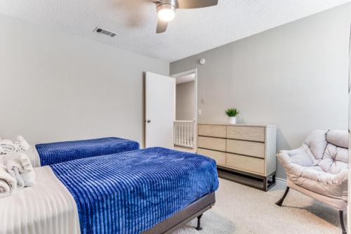 a bedroom with a bed and a dresser and a chair at Texas - Reston 1513 in McKinney