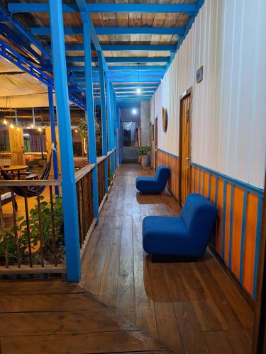 a hallway with blue columns and blue chairs in a building at Hostal Boutique El Rocio in Murillo