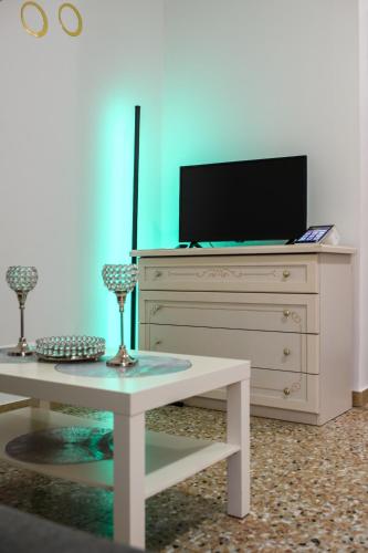 a white dresser with a tv on top of it at Laura Home in Verona