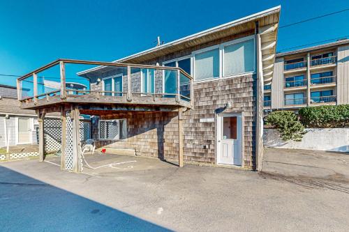 a building with a balcony on the side of it at Flounder's Crib Condo in Lincoln City