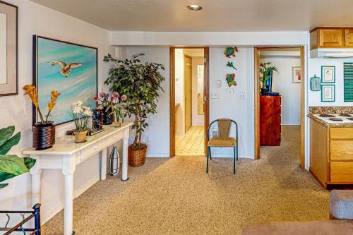 a kitchen with a table and chairs and plants at Flounder's Crib Condo in Lincoln City