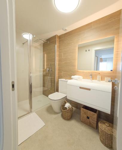a bathroom with a toilet and a sink and a shower at Casa Neroli ICONIC Gran Alacant in Gran Alacant