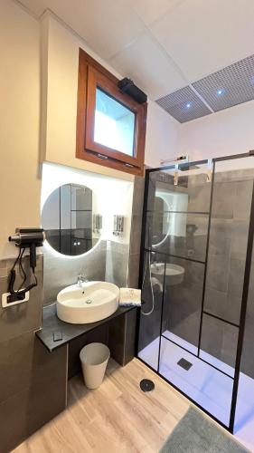 a bathroom with a sink and a shower at Kapo Azzurro in Monterotondo