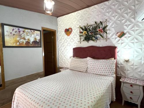 Una cama o camas en una habitación de Pousada Cascata dos Amores