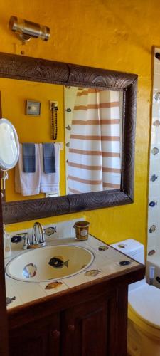 a bathroom with a sink and a mirror at Villas del Amor Amor in Puerto Vallarta
