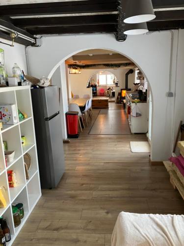 an arched hallway with a kitchen and a living room at Gîte La Belle Vue, Maison de campagne pour 21 personnes avec vue magnifique in Plainfaing