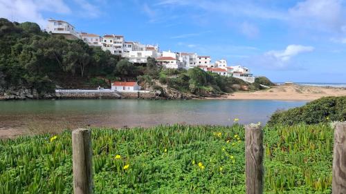 a view of a river with houses on a hill at Casa do Rio in Odeceixe