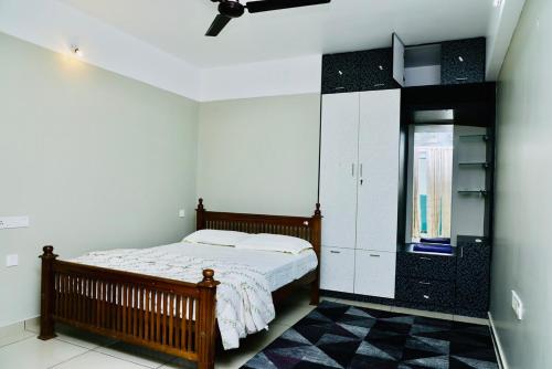 a bedroom with a bed and a black and white at Luxe Oasis Palm Opposite LULU Mall Thiruvananthapuram in Trivandrum