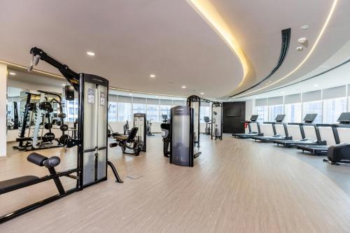 a gym with treadmills and chairs in a building at Le Royal Meridien Abu Dhabi in Abu Dhabi