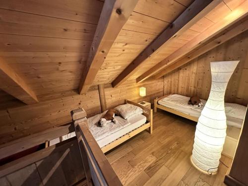 two dogs laying on beds in a wooden room at Chalet Des Bois - CHALET DES BOIS AU PIED DES PISTES MAE-2681 in Corrençon-en-Vercors