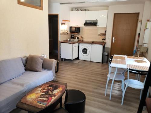 a living room with a couch and a table at Résidence Rue De La Paix - T2 PLEIN CENTRE VILLAGE MAE-3731 in Villard-de-Lans