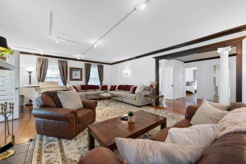a living room with couches and a table at - King Bed - Massive Yard - Fully Equipped Condo in Geneva