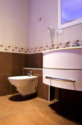 a bathroom with a sink and a toilet at Dolce Vita Suites Boutique in Prague