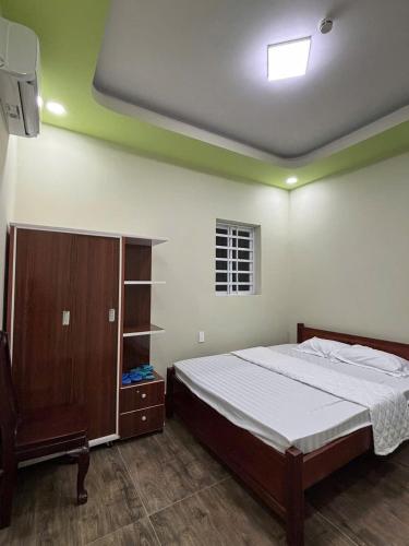 a bedroom with a bed and a tv in it at HOTEL MOTeL Đồng Khởi in Giồng Tú Ðiền