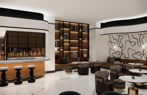 a restaurant with a bar and some tables and chairs at Hyatt Centric Chicago Ohare in Rosemont