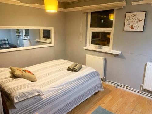 a bed in a room with two pillows on it at Brixton/Oval House in London