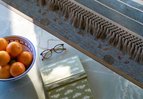 a bowl of oranges and a bowl of glasses on a table at The Sanderling in Duck