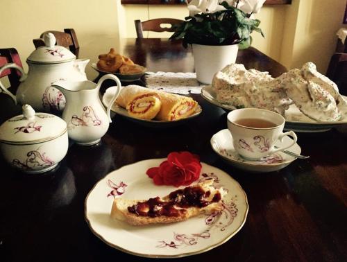 a table with plates of food and cups of coffee at Casale il Cerqueto in San Severino Marche