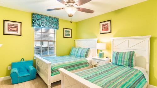 a bedroom with two beds and a ceiling fan at BRL4805 in Orange Park
