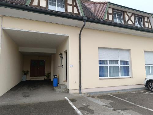 a garage entrance to a house with a driveway at Grand Appartement 3 frontières in Hésingue