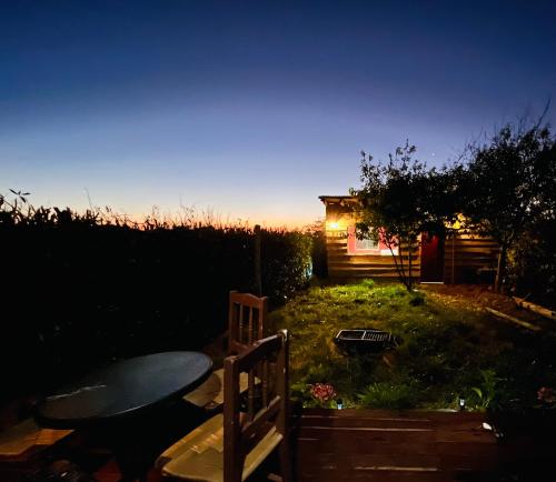 a view of a backyard with a table and a house at Casa Costa Ñuble in Cobquecura