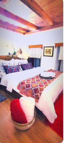 a bedroom with a large bed with a comforter at Ela's Chalet in Old Bazaar Gjirokaster in Gjirokastër