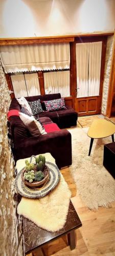 a living room with a couch and a table at Ela's Chalet in Old Bazaar Gjirokaster in Gjirokastër