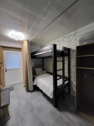 a bedroom with two bunk beds in a room at Maison 4p, parking, terrasse, jardin in Chancenay
