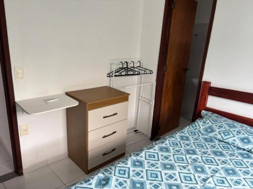 a small bedroom with a bed and a sink at Casa da Ilha de Boipeba in Ilha de Boipeba