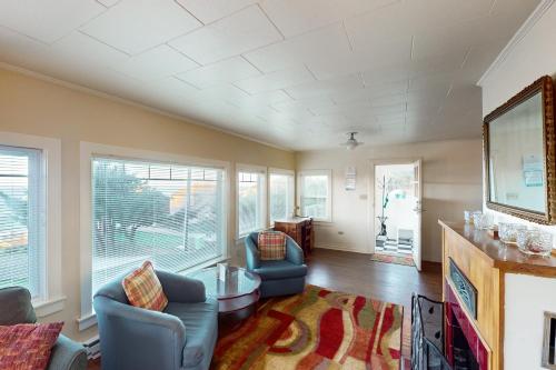 a living room with two chairs and a table at Whale - Watcher's Perch in Depoe Bay