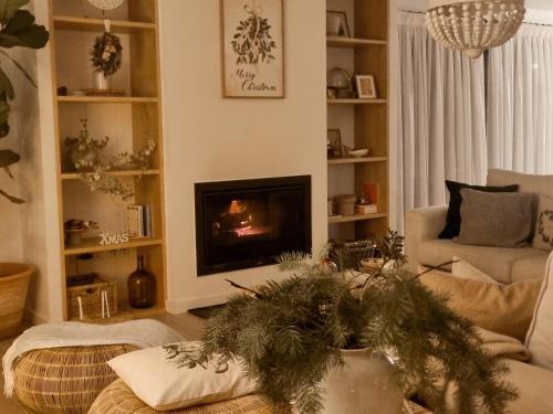 a living room with a fire in the fireplace at Quinta das Levadas - Country House & Nature in Alvoco das Várzeas