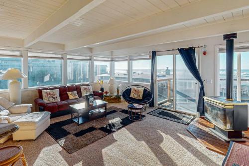 a living room with a couch and a tv at Sebastian's Crib Condo in Lincoln City