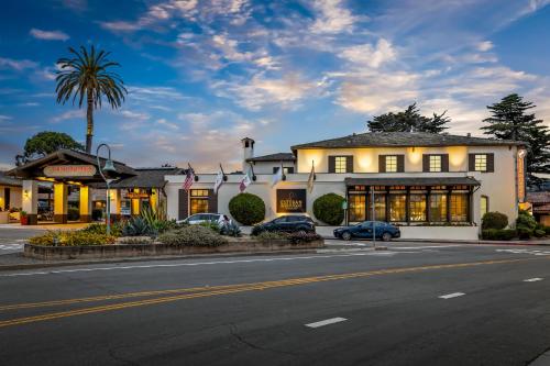 a building with cars parked in front of a street at Casa Munras Garden Hotel & Spa in Monterey