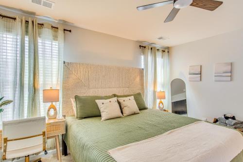 a bedroom with a green bed with a ceiling fan at Near Golf Courses Cozy Home in Ocean Isle Beach! in Ocean Isle Beach