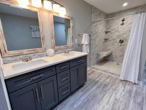 a bathroom with two sinks and a shower at Bayou 565 - Panhandle Paradise in Marietta