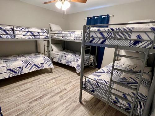 a room with three bunk beds and a fan at Bayou 565 - Panhandle Paradise in Marietta