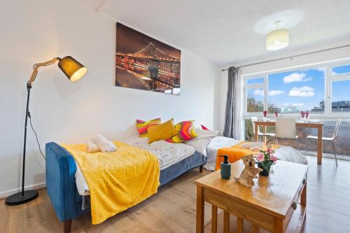a living room with a bed and a table at Luxury 2 Bedroom Apartment with Free Parking Opposite Queen Elizabeth Hospital in Birmingham
