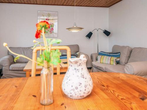 two vases sitting on a wooden table in a living room at 5 person holiday home in Sydals in Trænge