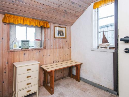 a wooden room with a bench and two windows at 5 person holiday home in Sydals in Trænge