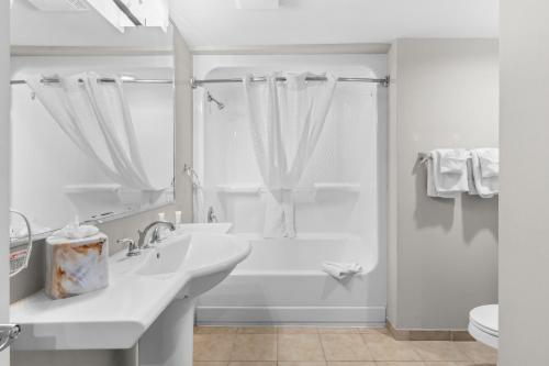 a white bathroom with a sink and a shower at Seaside Resort in Myrtle Beach