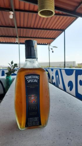 a bottle of something special sitting on a table at Hotel Terraliz in Galapa