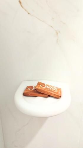 a close up of a toilet bowl with a pair of scissors at Hotel Terraliz in Galapa