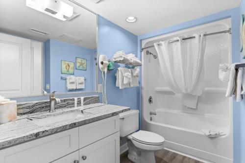 a bathroom with blue walls and a toilet and a shower at Seaside Resort in Myrtle Beach