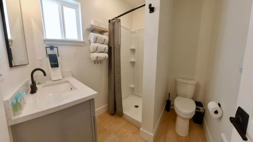 a white bathroom with a sink and a toilet at Cozy Studio in Heart of CDA Only 5 Min to the Resort And Lake in Coeur d'Alene