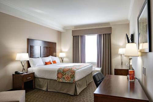 a hotel room with a bed and a desk at Coast Oliver Hotel in Oliver