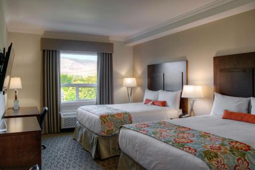 a hotel room with two beds and a window at Coast Oliver Hotel in Oliver