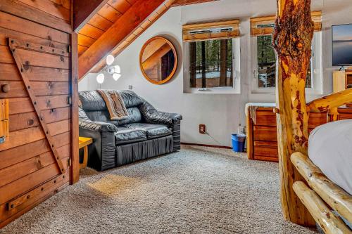 a bedroom with a couch and a bed in a tiny house at Kings Beach Cabin Private Hot Tub, Near Lake & Ski in Kings Beach