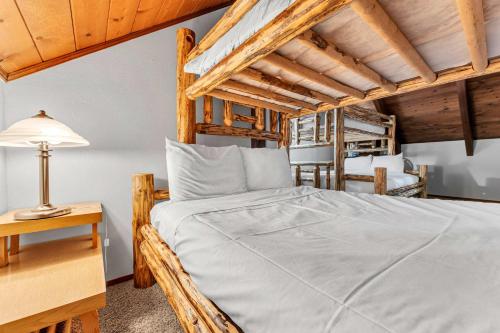 a bedroom with a bed and a lamp on a table at Kings Beach Cabin Private Hot Tub, Near Lake & Ski in Kings Beach